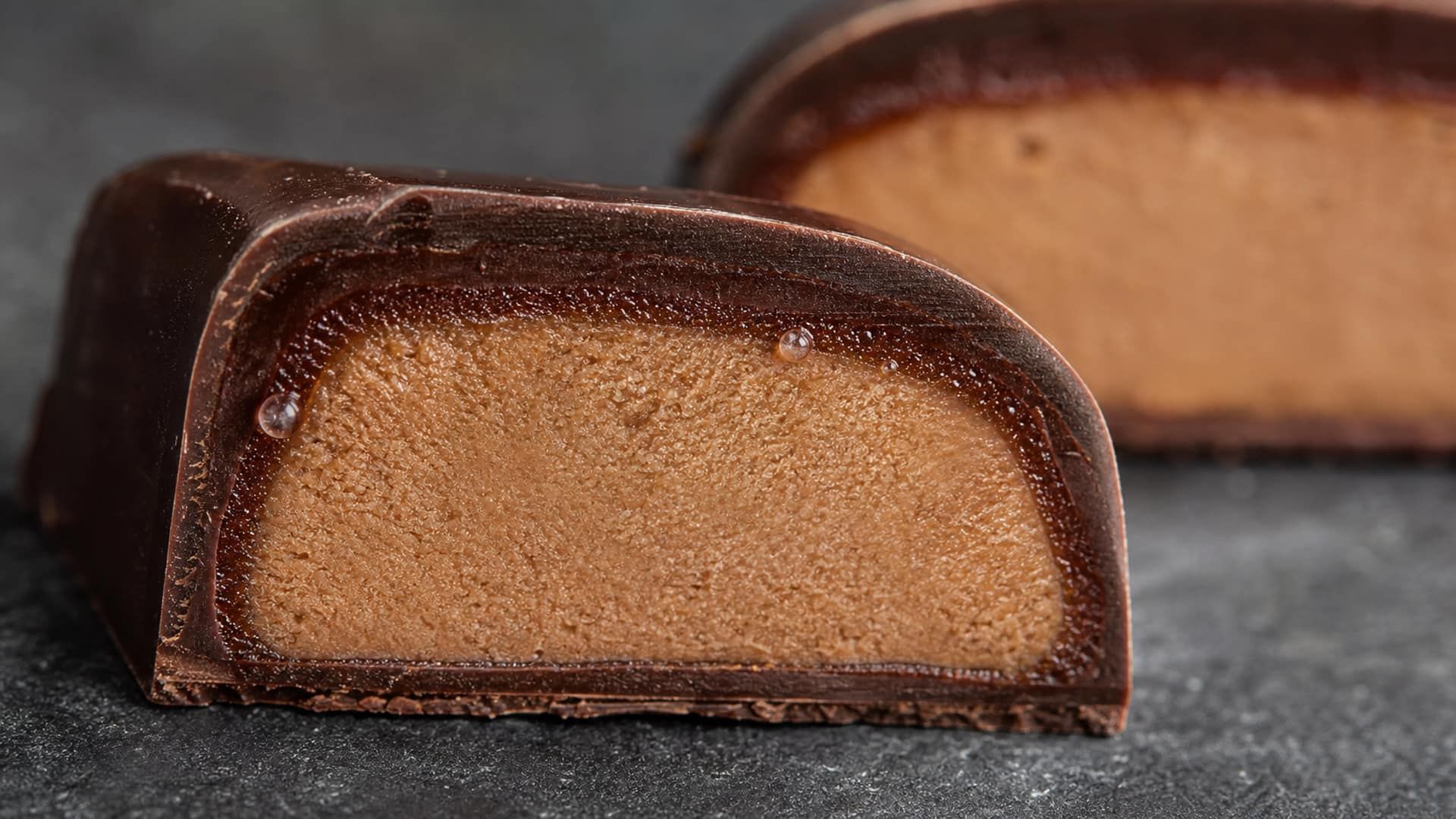 A filled chocolate cross-section showing a moisture front creeping from the centre.